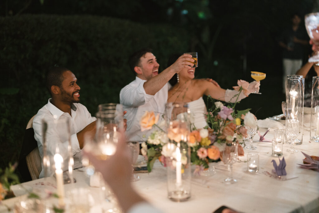 bride and groom toasting with guests at intimate Thailand wedding reception