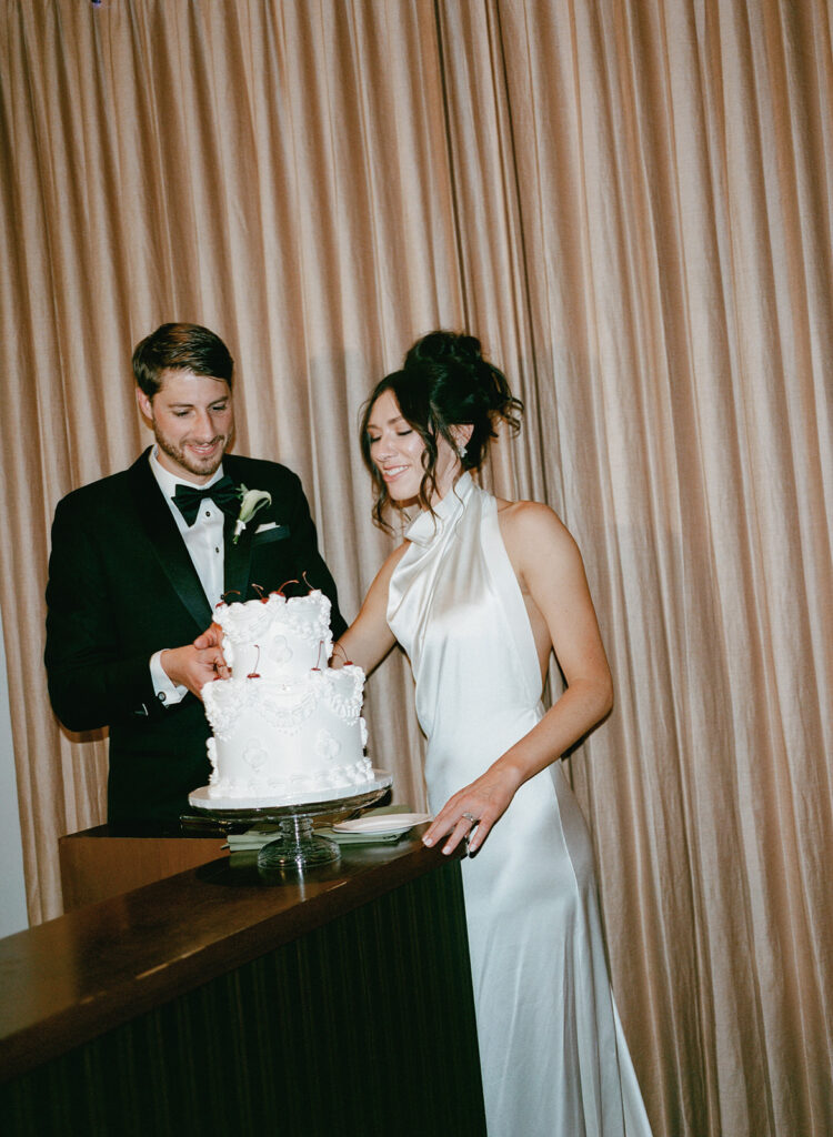 Detroit bride and groom cutting wedding cake