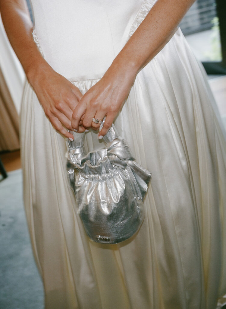 Bride holding silver handbag