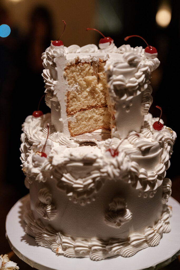 Flash photography shot of wedding cake with a slice missing