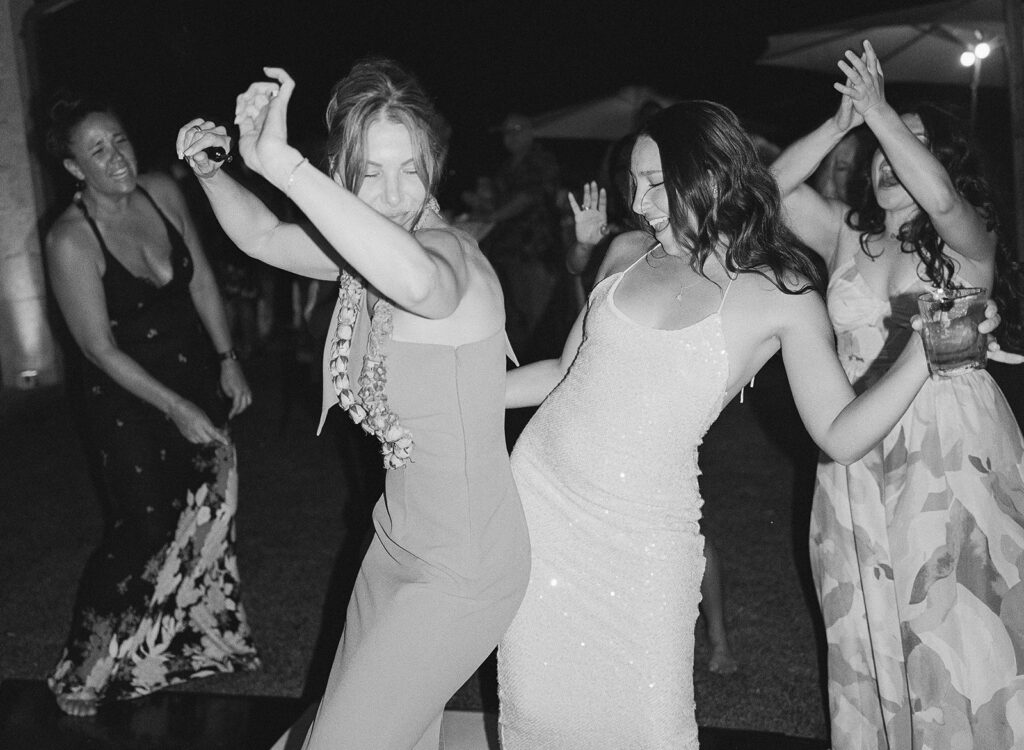 black and white candid of bride dancing during reception