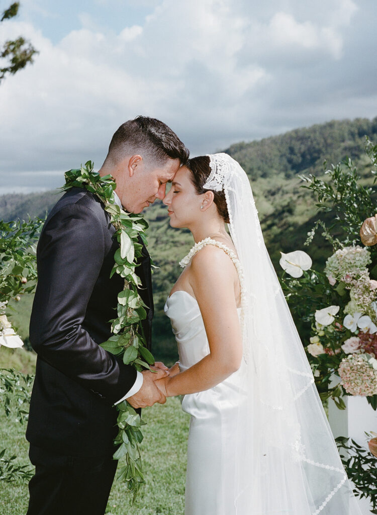 Bride and groom with foreheads resting against each other