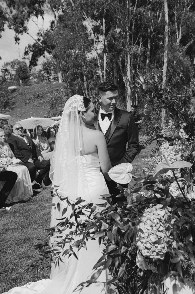 Bride and groom looking at officiant during wedding ceremony