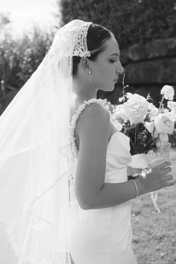 Bride wearing vintage veil with intricate lace headpiece