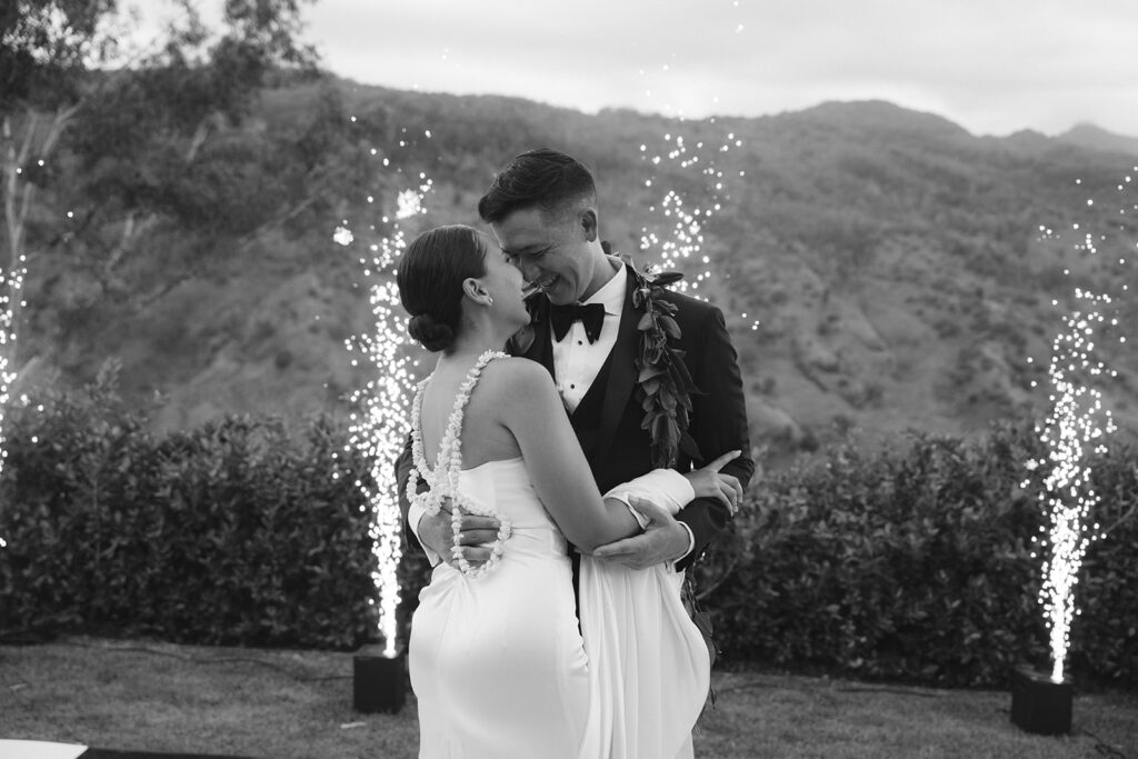 Bride and groom first dance with sparklers in the background