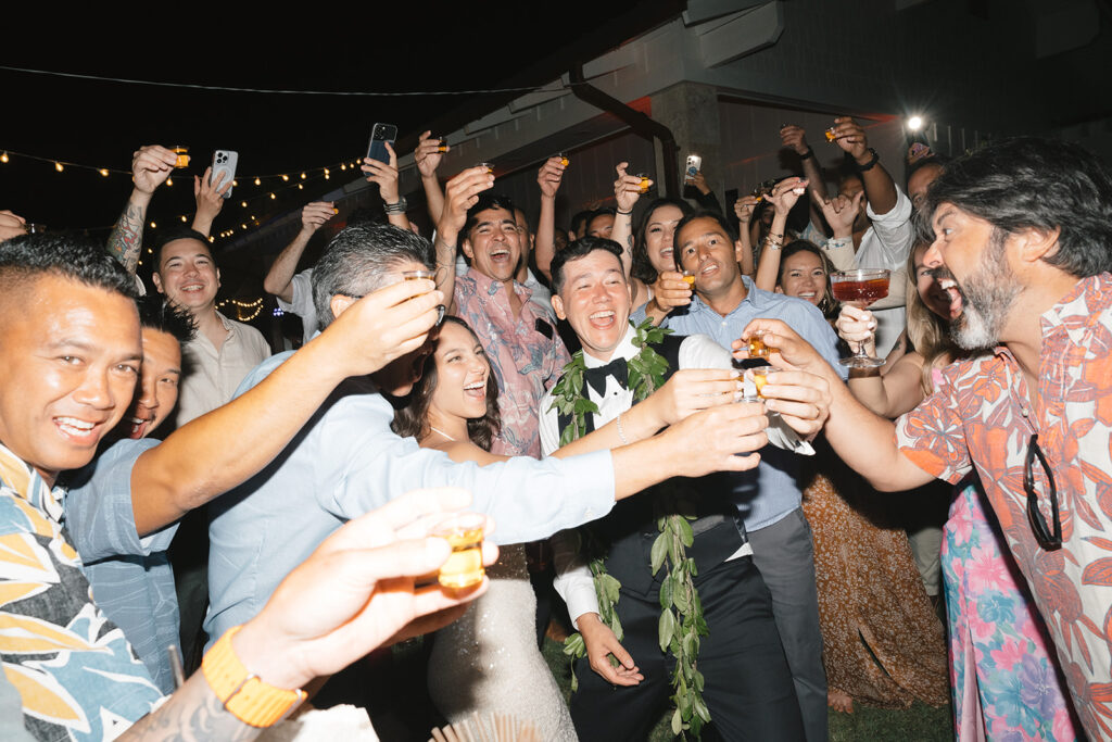 Guests all toasting on wedding reception dancefloor