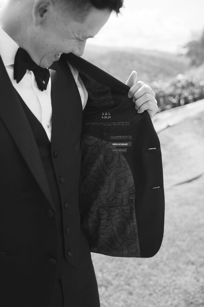 Peek inside groom's suit jacket to reveal personalized stitching