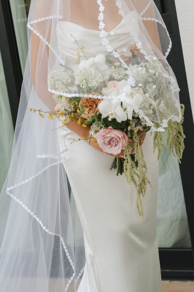 Oahu bride with bridal bouquet and vintage veil