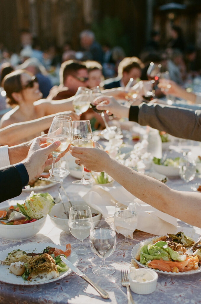 Wedding guest cheersing over dinner