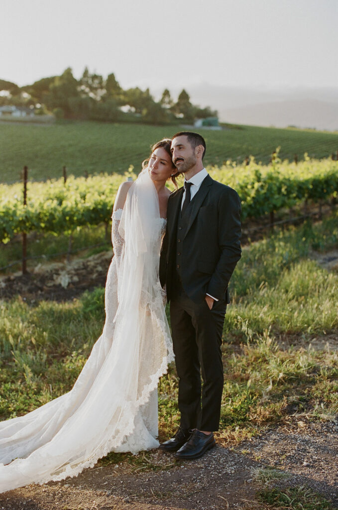 Romantic bride and groom posing in golden light