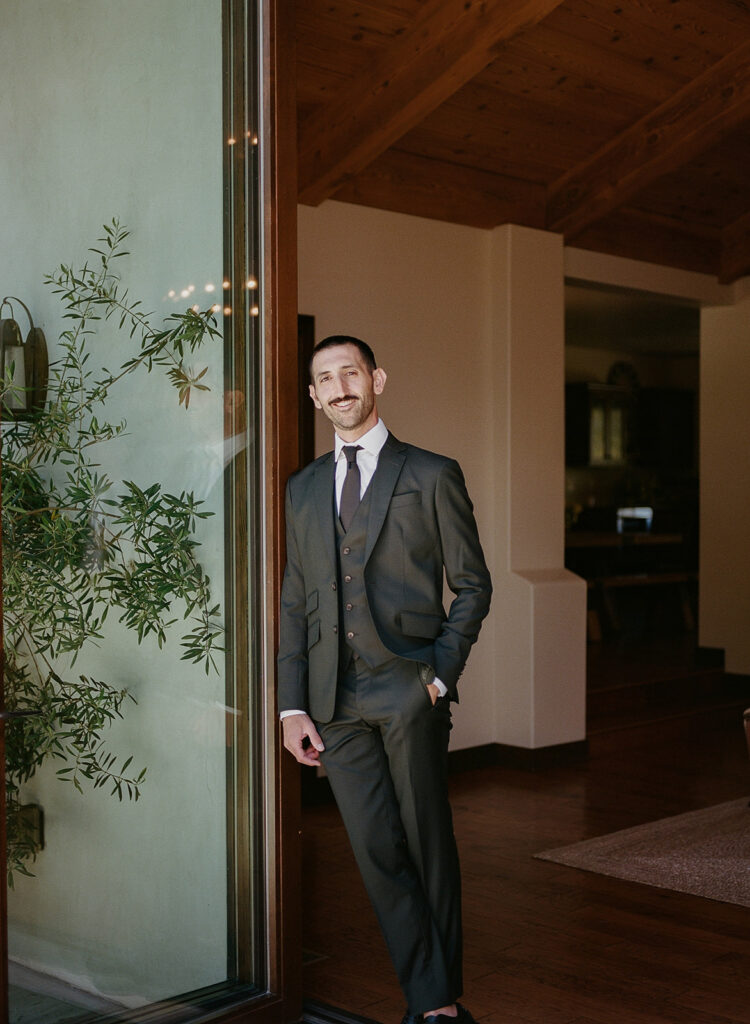 Groom portrait in doorway at Greengate Ranch wedding