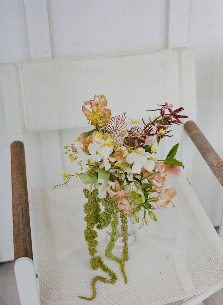 Closeup bridal bouquet set on white chair